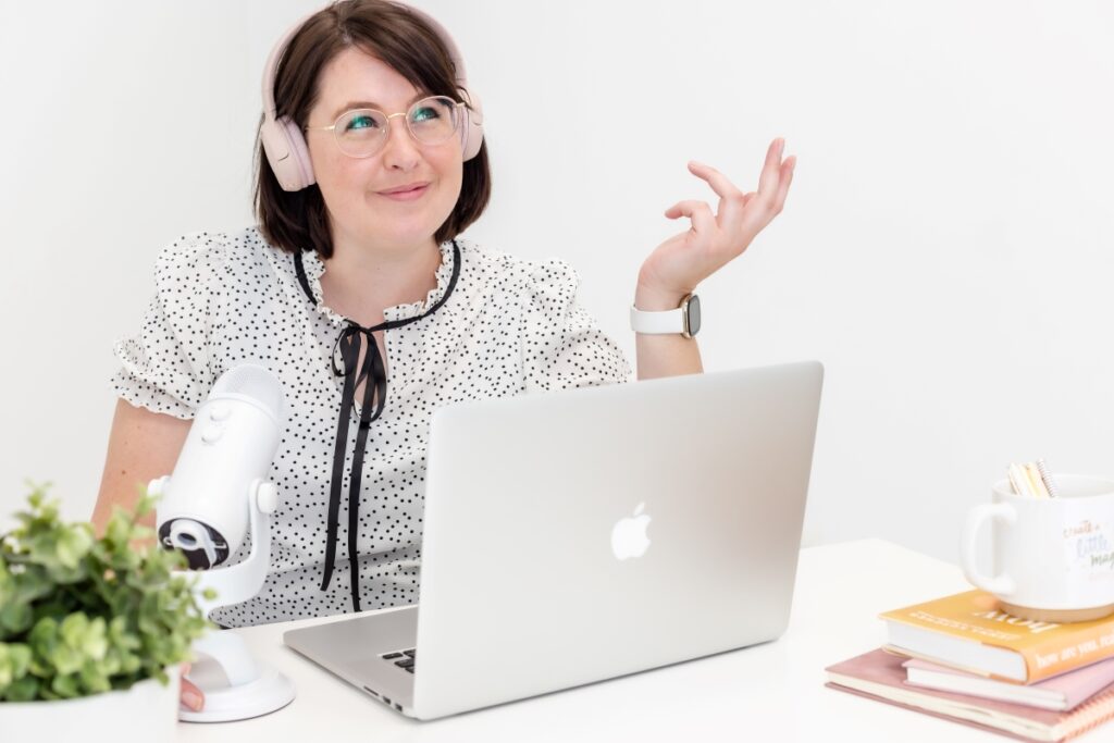A woman at a desk with a laptop, providing beginner's guide on copywriting and content writing for websites.